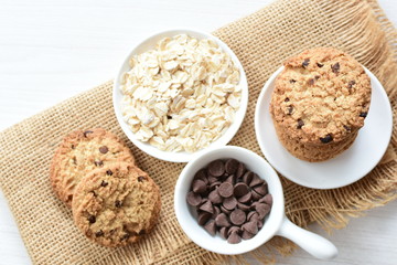 Oatmeal cookies and chocolate chips on cloth background