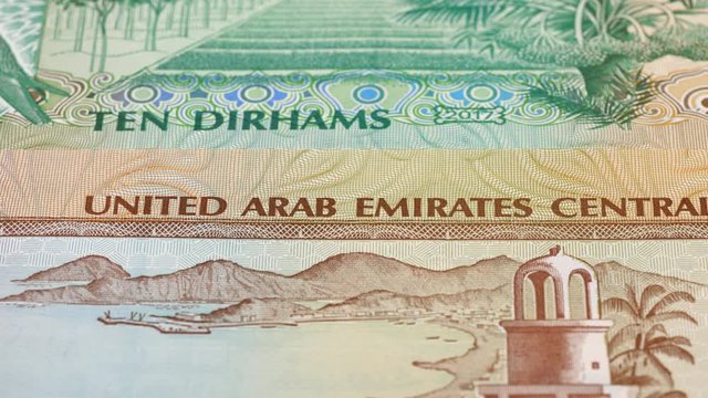 UAE dirham notes tracking. United Arab Emirates currency background. Slider shot. Low angle, macro. 4K