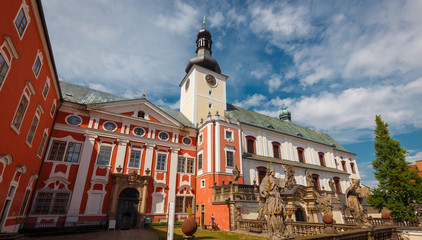 Obraz premium Broumov Monastery exterior during sunny day with blue sky, Nachod district, Czech Republic, Europe