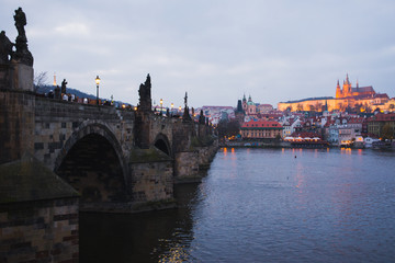 Fototapeta na wymiar Evening walk sightseeing traveling fall to Prague, Czech Republic. Charles bridge and promenade.
