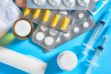 Different medicaments for disease treatment on blue background. Medical concept
