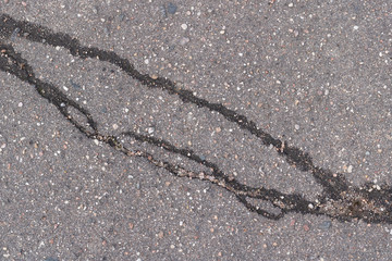 crack on asphalt . asphalt road with ruined asphalt . close up