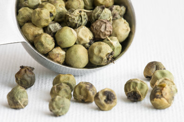 Green Peppercorns Spilled from a Teaspoon