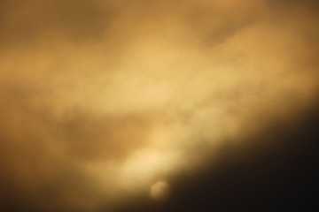 Dramatic lit by sun rising fog over water.