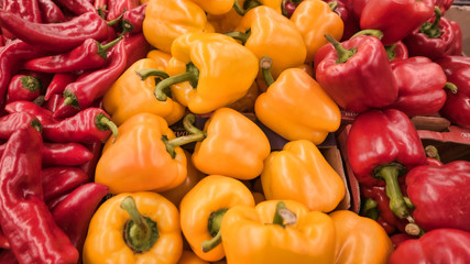red and yellow bell peppers lie on the table