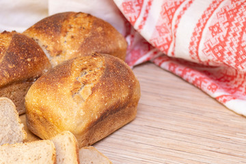 Bakery - golden rustic bread crusts. Fresh aromatic bread on the table. Food concept.