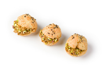 Eclairs with liver pate and pistachio nuts on a white background