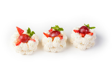 cake beeMeringue cake with strawberries and grapes on a white background