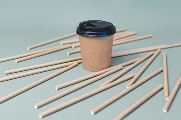 Craft coffee cups with paper straw on gray background. Eco friendly design. Zero waste, plastic free items