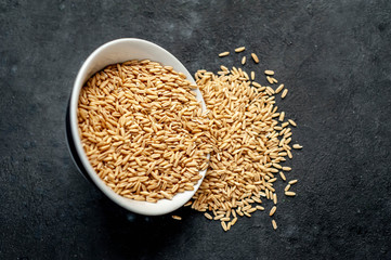 oatmeal grains in a white mask on a stone background