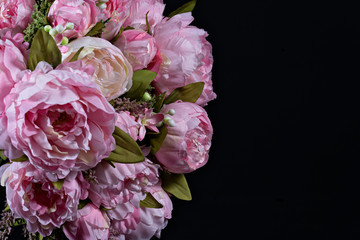 Beautiful bouquet of pink peonies close up. Floral composition on black background.