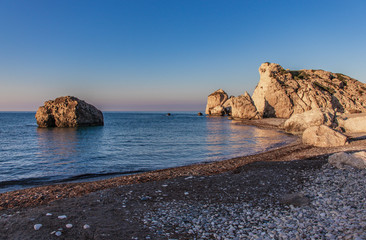 the most romantic beach on the cyprus petra tou romiou, place of birth godness aphrodita, beach, rocks in the sea during sunrise and beautiful blue and purple sky