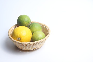 citrus fruits in a basket isolated on white background flat lay