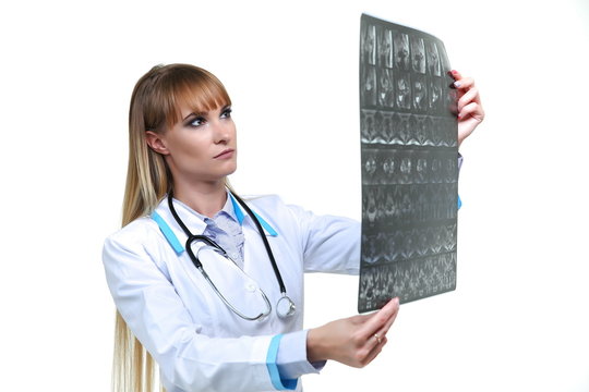woman doctor looking through an x ray image isolated on white background