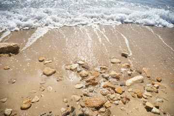 Blue foam waves on the sea beach
