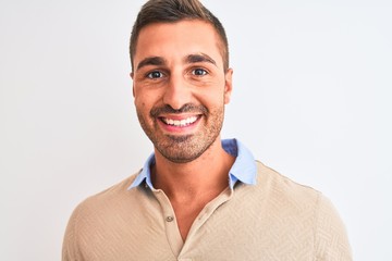 Fototapeta premium Young handsome man wearing elegant t-shirt over isolated background with a happy face standing and smiling with a confident smile showing teeth