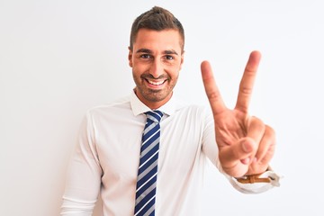 Young handsome elegant business man over isolated background smiling looking to the camera showing fingers doing victory sign. Number two.