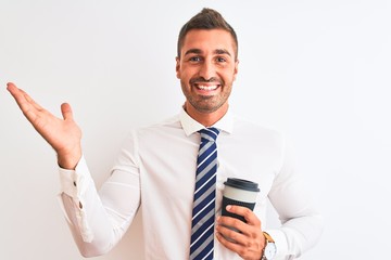 Young handsome business man drinking take away coffee over isolated background very happy and excited, winner expression celebrating victory screaming with big smile and raised hands