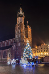 Fototapeta na wymiar Krakow, Poland, Christmas tree on Main Square and St Mary's church