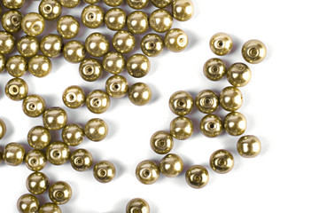 Large brown beads are scattered over a white isolated background