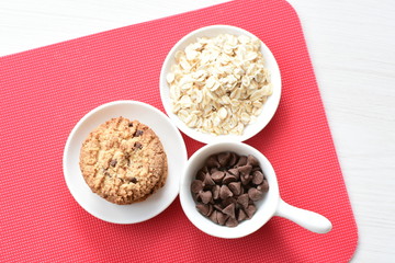Oatmeal cookies and chocolate chips on colorful background