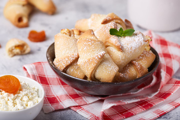 Mini croissant cookies with cottage cheese and dried apricots. Delicious homemade dessert.