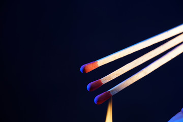 Lit matches and blown out in the studio photographed with colorful foils before the flashes