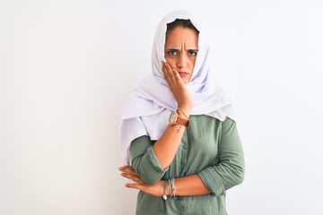 Young beautiful Arab woman wearing traditional Muslim hijab over isolated background thinking looking tired and bored with depression problems with crossed arms.