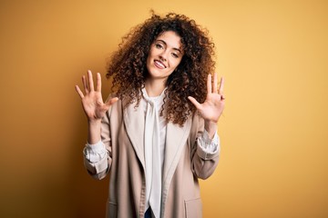 Young beautiful brunette woman with curly hair and piercing wearing casual t-shirt and diadem...