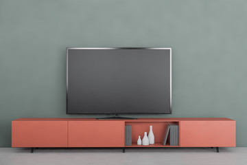 Modern TV on orange cabinet in green living room