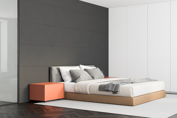 Gray master bedroom corner with orange tables