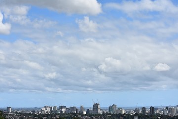 A City Skyline And Cloudy Sky