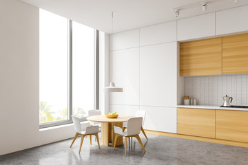 White and wood kitchen corner, table and window