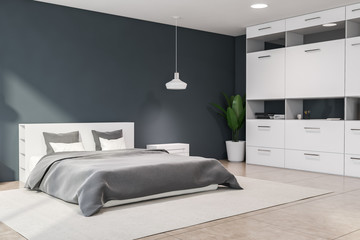 Dark grey master bedroom corner with bookcase