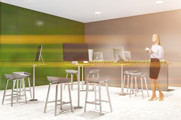 Woman in green coworking style office