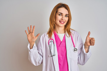Redhead caucasian doctor woman wearing pink stethoscope over isolated background showing and pointing up with fingers number six while smiling confident and happy.