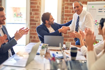 Group of business workers smiling happy and confident. Working together with smile on face applauding one of them at the office