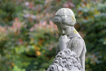 Fototapeta na wymiar statue of sorrow at municipal cemetery in Amsterdam at springtime, The Netherlands