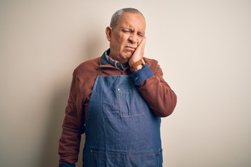 Senior handsome baker man wearing apron standing over isolated white background thinking looking tired and bored with depression problems with crossed arms.