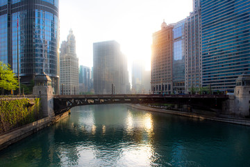 A view of the Wabash Avenue Bridge with the early morning sun glaring in a haze between the distant buildings