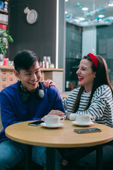 Happy couple laughing in the cafe stock photo