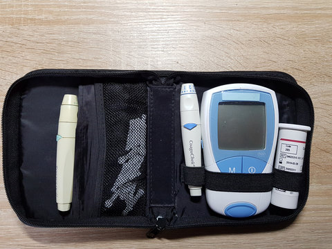 HEILIGENHAUS, NRW, GERMANY - NOVEMBER 30, 2018: Coagulation Self Management with the CoaguChek. Medical device for the determination and monitoring of blood clotting.