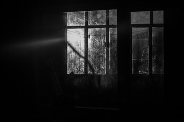 Sunrise outside the window. Misted glass against the backdrop of the rising sun. Winter morning. . Simple background. The ratio of cold and warm colors. Texture of water condensate on glass.