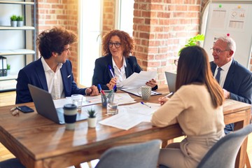 Group of business workers smiling happy and confident. Speaking with smile on face working together at the office.