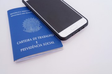 Brazilian work card and social security document (carteira de trabalho) and smartphone. Digital work card concept.