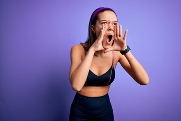 Young beautiful sporty girl doing sport wearing sportswear over isolated purple background Shouting angry out loud with hands over mouth