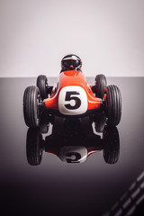 Red old racing car with number five painted on it