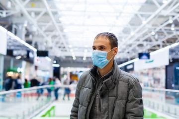 Fototapeta na wymiar Man wearing mask for protect Novel Coronavirus:2019 or PM 2.5 dust and serious of the air pollution in department store.