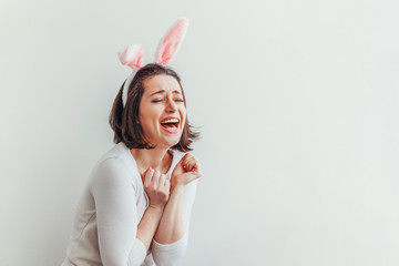 Obraz na płótnie Canvas Happy Easter holiday celebration spring concept. Young woman wearing bunny ears isolated on white background. Preparation for holiday. Girl looking happy and excited, having fun on Easter day