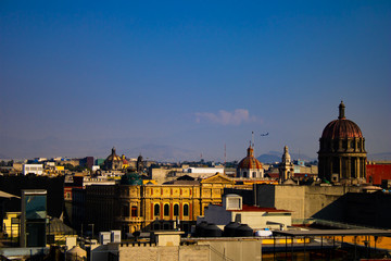 Fototapeta premium Beautiful landscape view of the historic centre of Mexico City, Mexico with an airplane at the horizon 